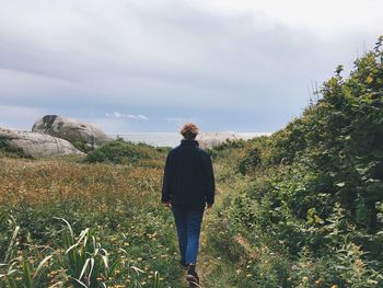 Rear view of woman walking in nature in norway