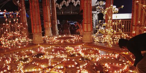 Statue of illuminated temple at night