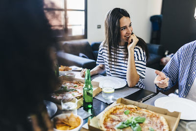 Friends having a pizza at home