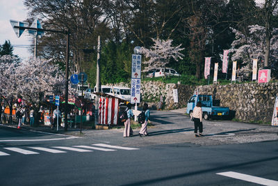 People walking on road in city
