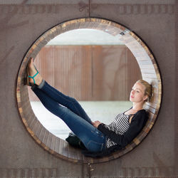 Portrait of beautiful woman sitting in corridor