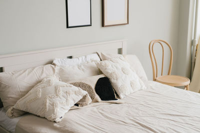 Bed in the bedroom in a scandinavian minimalist style. light pillows on the bed. 