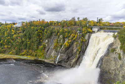 Scenic view of waterfall against sky