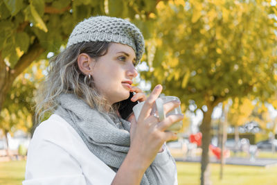 Portrait of young woman drinking water