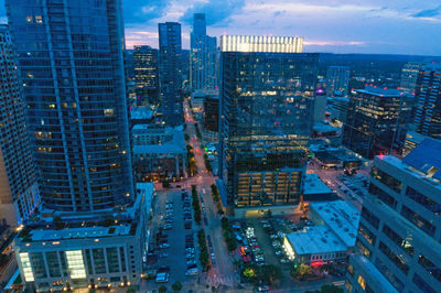 High angle view of illuminated buildings in city at dusk