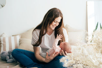 Mother and daughter sitting on floor