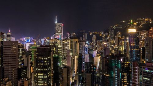 Aerial view of illuminated cityscape against sky at night