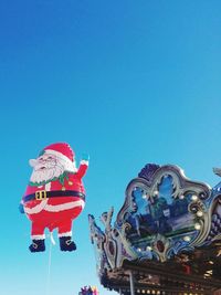 Low angle view of statue against clear blue sky