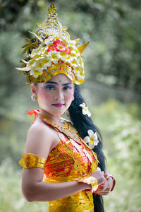 Portrait of young woman wearing hat standing outdoors