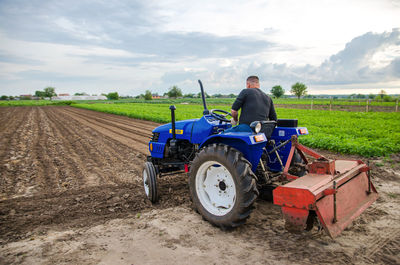 Kherson oblast, ukraine - may 29, 2021. a farmer on a tractor clears the field. milling soil,