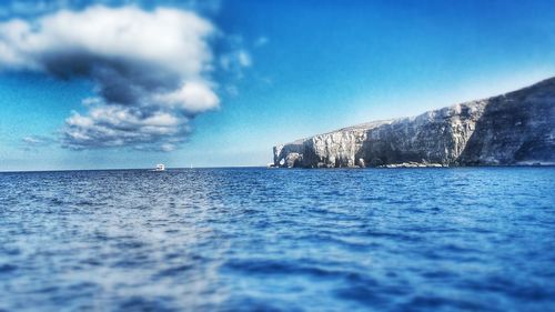 Scenic view of sea against blue sky