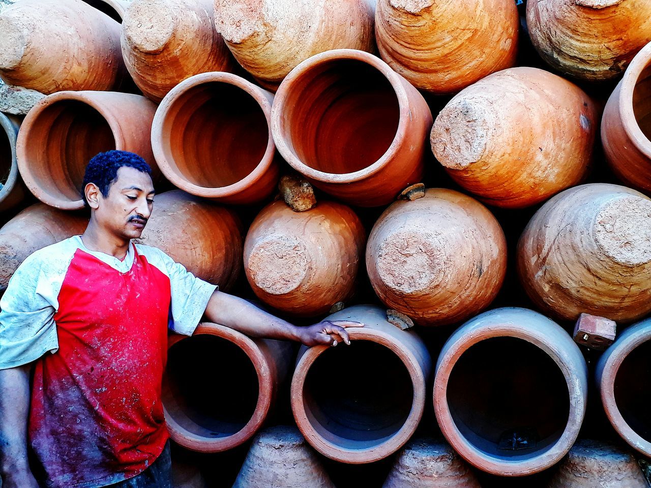 stack, day, large group of objects, real people, outdoors, earthenware, one person, people