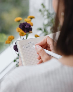 Midsection of woman reading book