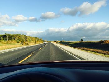 Empty road against sky seen through car windshield