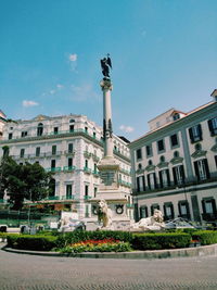 Low angle view of buildings against blue sky