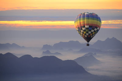 Low angle view of hot air balloon flying in sky during sunset