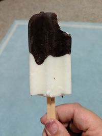 Close-up of hand holding ice cream cone