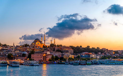 View of buildings in city at sunset