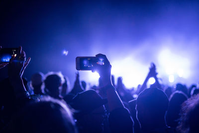 People enjoying music concert at night