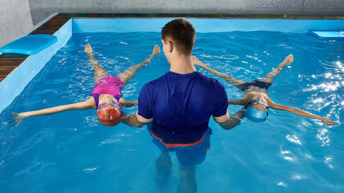 High angle view of woman swimming in sea
