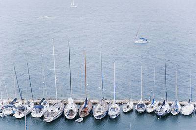 High angle view of sailboats moored in sea