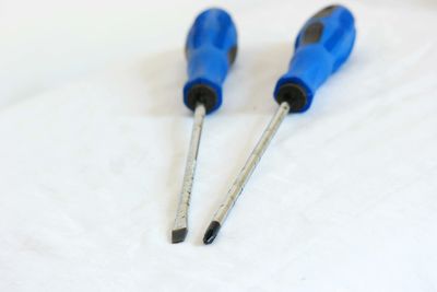 Close-up of screwdrivers on white fabric