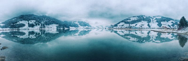 Scenic view of lake against cloudy sky