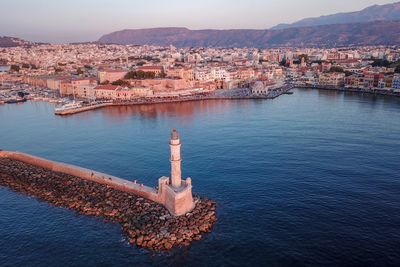 High angle view of townscape by sea against sky