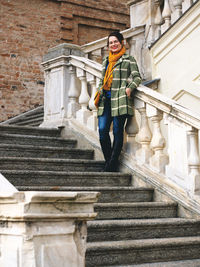 Portrait of woman standing on staircase