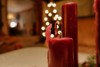 Close-up of illuminated candles on table