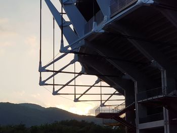 Low angle view of stadium against sky at sunset