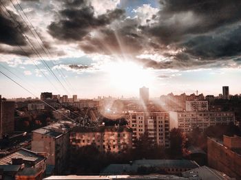 Aerial view of townscape against sky at sunset