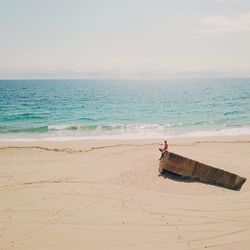 Man standing on beach against sky