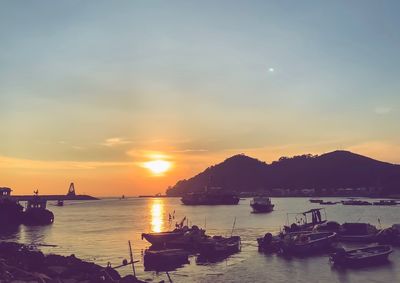 Boats in marina at sunset
