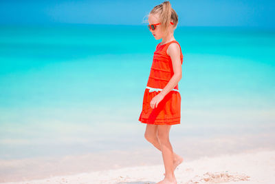 Full length of woman at beach against sky