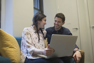 Young professionals working on laptop in an office