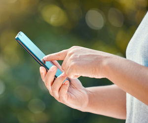 Midsection of woman using mobile phone