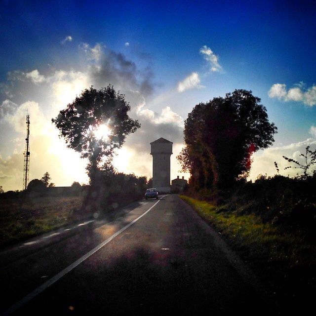 the way forward, transportation, road, tree, sky, diminishing perspective, vanishing point, country road, road marking, sun, sunset, cloud - sky, sunlight, street, empty road, cloud, silhouette, empty, nature, tranquility