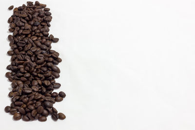 Close-up of coffee beans against white background