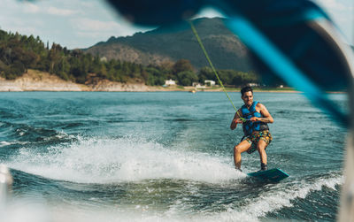 Full length of man doing wakeboard in a lake