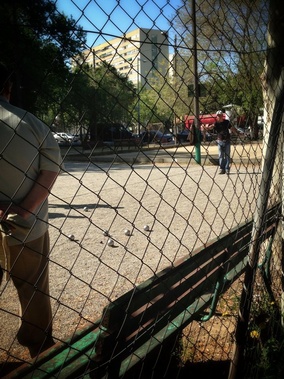 transportation, chainlink fence, protection, fence, mode of transport, safety, land vehicle, city, tree, metal, men, incidental people, built structure, travel, day, railroad track, building exterior, security