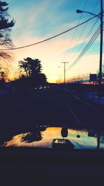 Cars on road at sunset