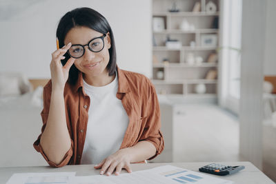 Young businesswoman working at desk in office