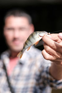 Close-up of hand holding fish