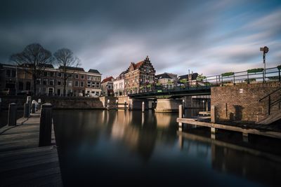 View of bridge over river against cloudy sky