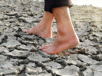 Low section of person standing on rock