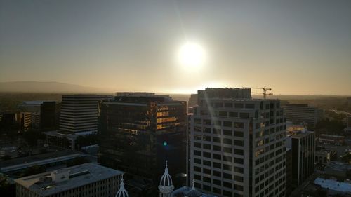 Cityscape against clear sky during sunset