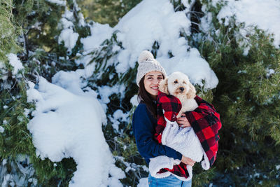 Woman with dog in snow