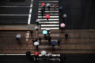 High angle view of people crossing road in city