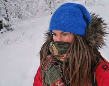Close-up of woman with dreadlock in snow